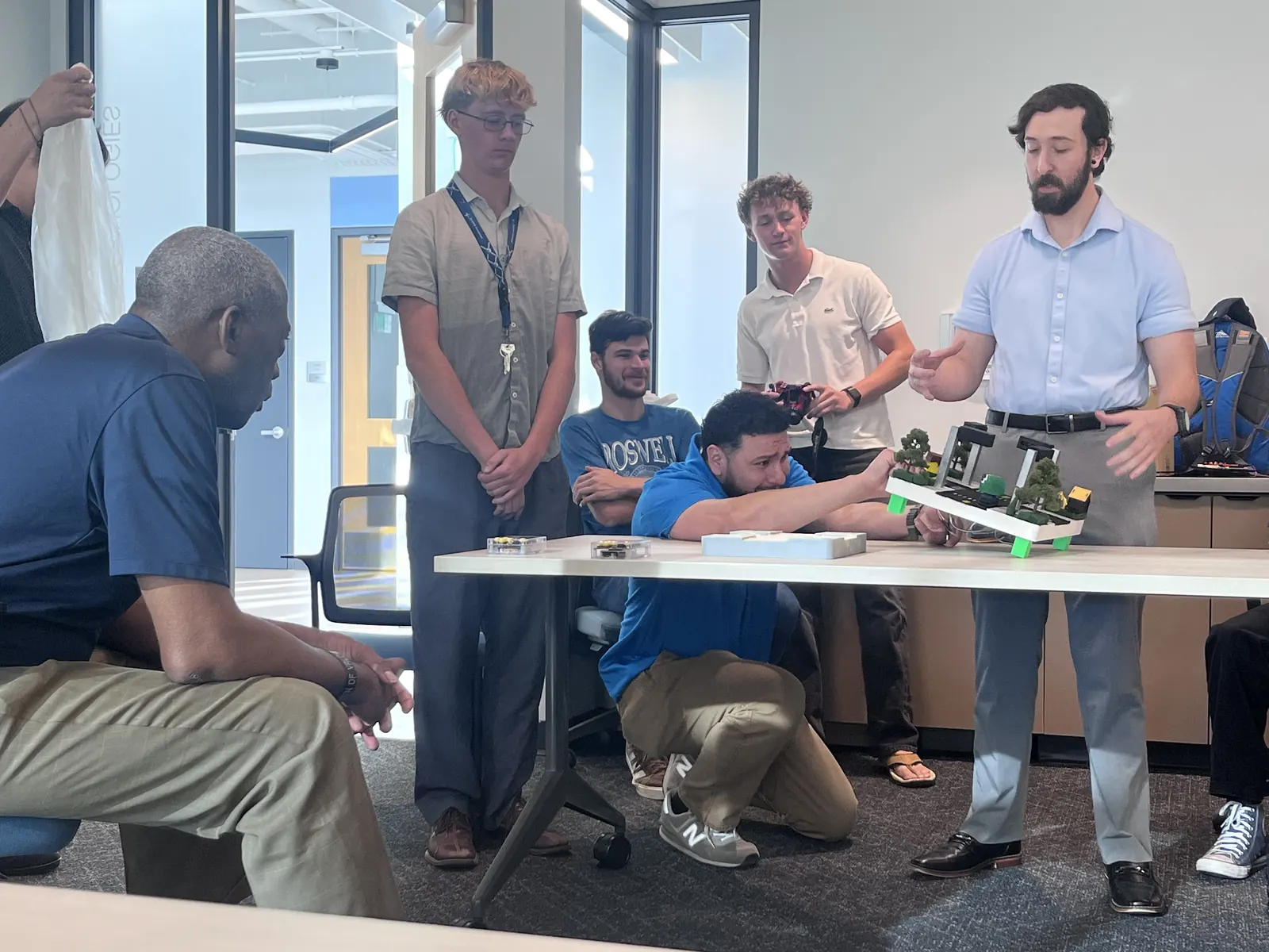 Members presenting the traffic light intersection model to an audience